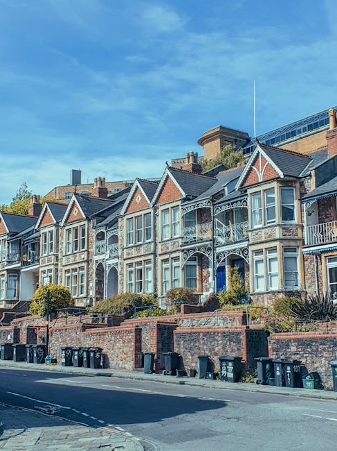 A row of Victorian-style terraced houses on Church Road, NW10, featuring brick facades, ornate white window frames, and small front gardens. The buildings have peaked roofs with decorative trim, and s
